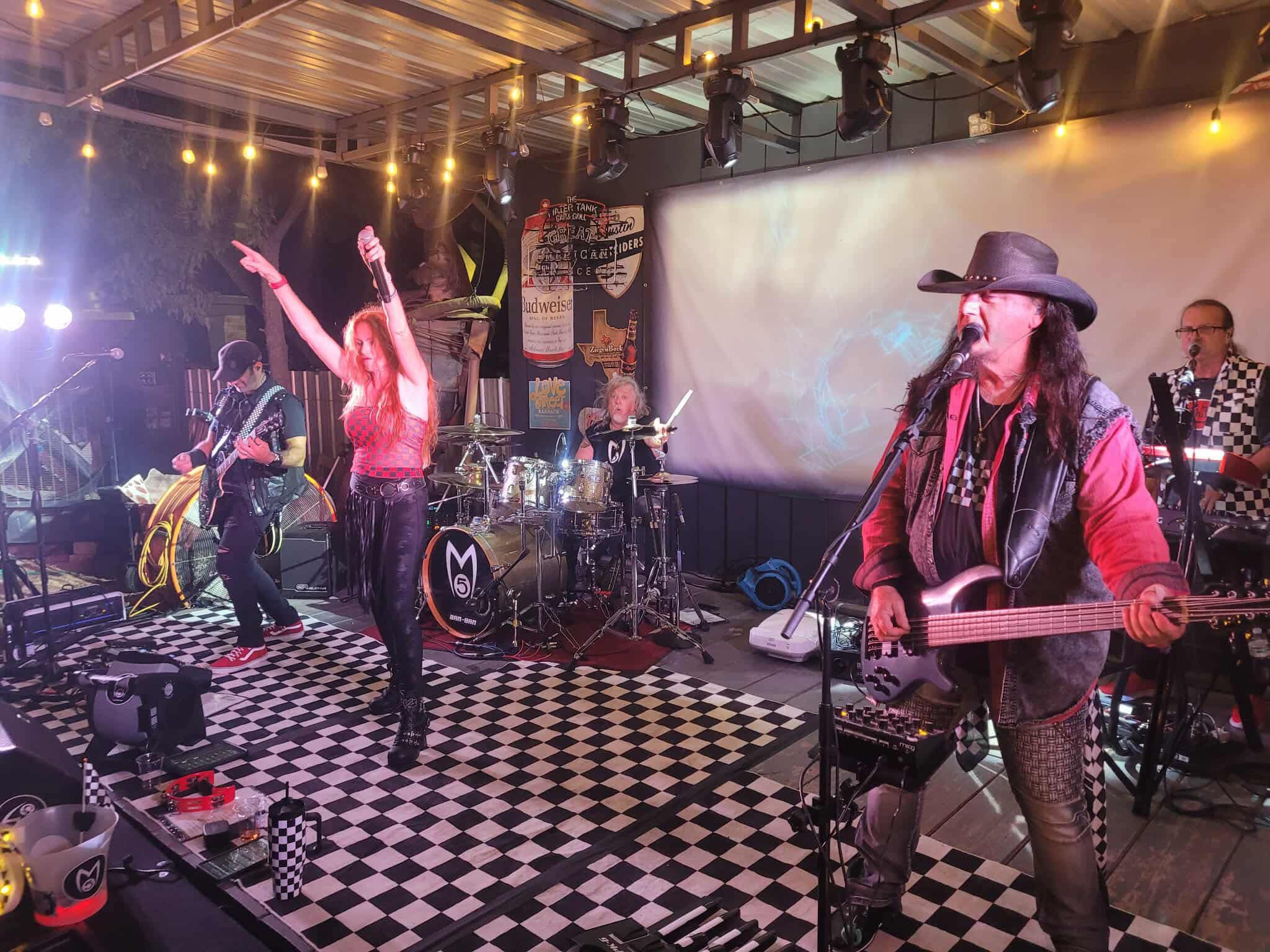 Mach 5 performing live under stage lighting